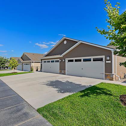 a large garage with a tree in front of it.