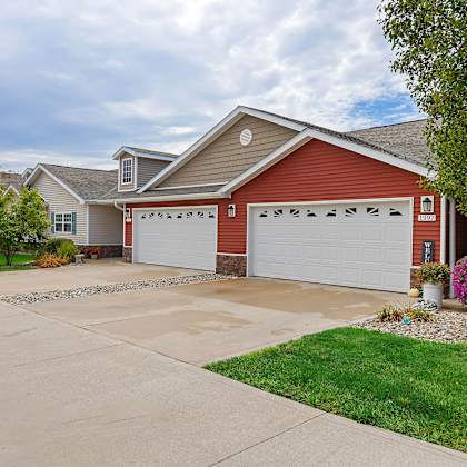 a red house with a white garage door.