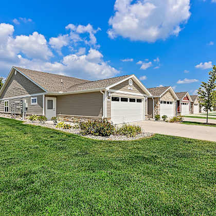 a house with a garage and a driveway in front of it.
