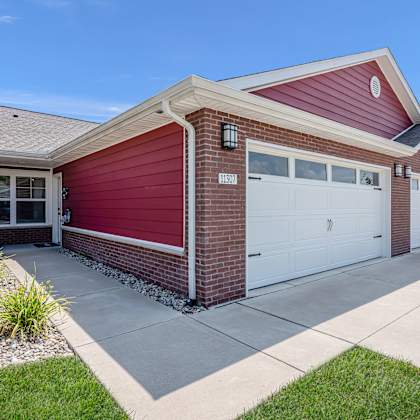 a red house with a white garage door.