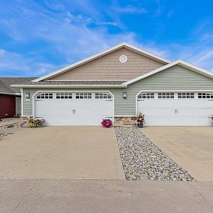 a two-car garage is attached to a house.
