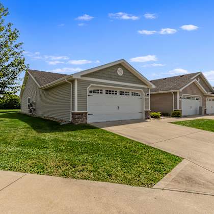 a row of houses with garages and driveways.