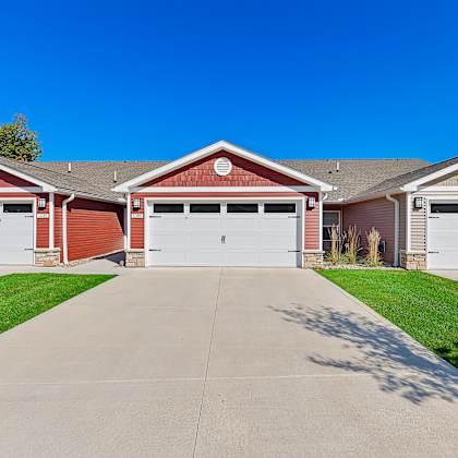 a row of garages with a car parked in the first one.