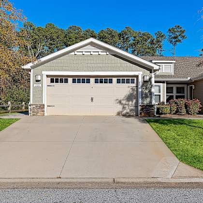 a two-car garage is attached to a house.