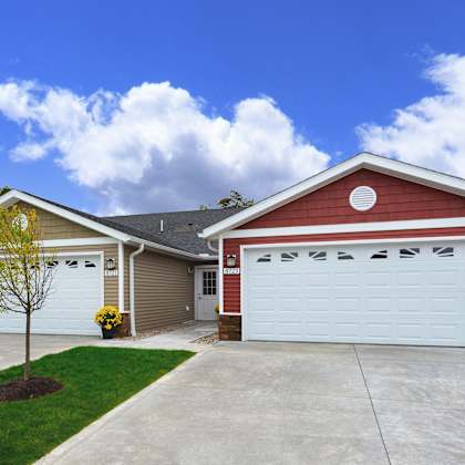 a red house with a white garage door.