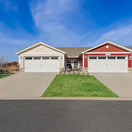 a house with two garages, one red and one white.