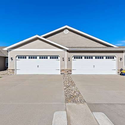 a two-car garage with a stone border in front.