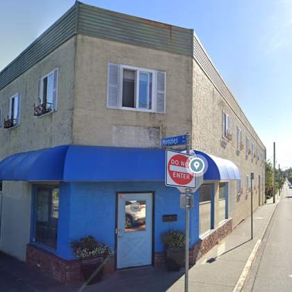 a blue and white building with a sign that says "do not enter".