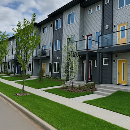 apartment building with a grey facade and yellow doors.