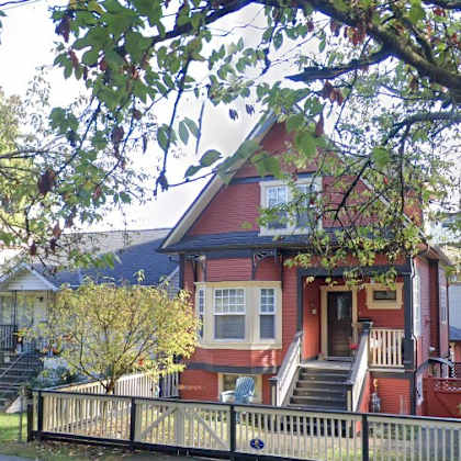 a red house with a white door and windows.