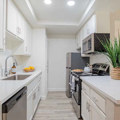 kitchen with white cabinets and stainless steel appliances at banbury apartments riverside
