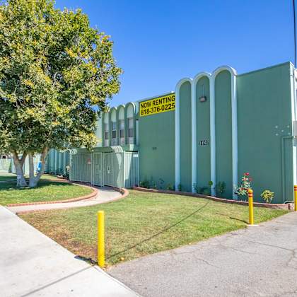 a building with a yellow street sign in front of it