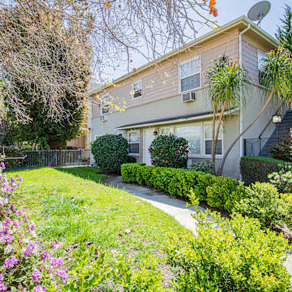 a house with a well-maintained garden in front.