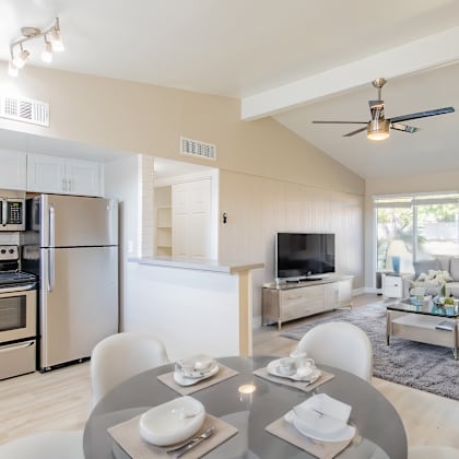 a modern kitchen with a dining table set for two.