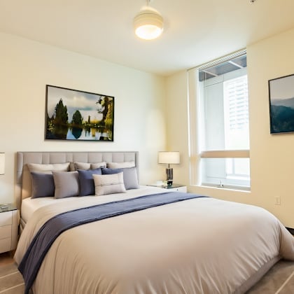 a bedroom with a large bed and a window