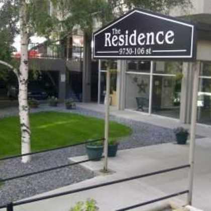 a sign for "the residence" is displayed on a building.