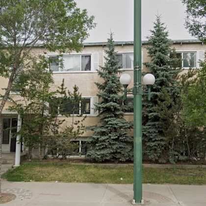 a building with a green pole in front of it.