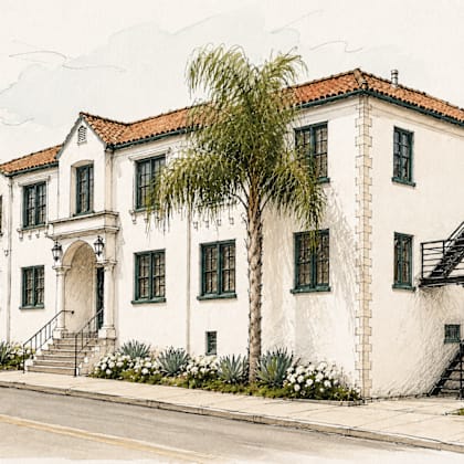 a white building with a red tile roof and a black staircase.