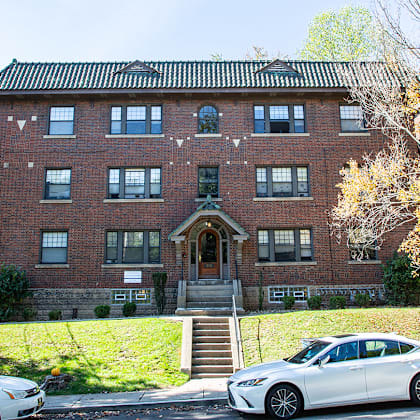 a large brick building with cars parked in front of it