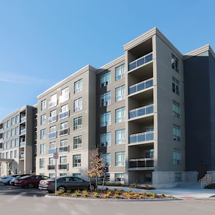 a large apartment building with a parking lot in front of it