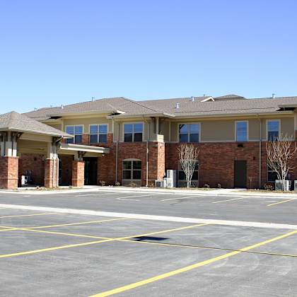 a parking lot in front of a row of apartment buildings.