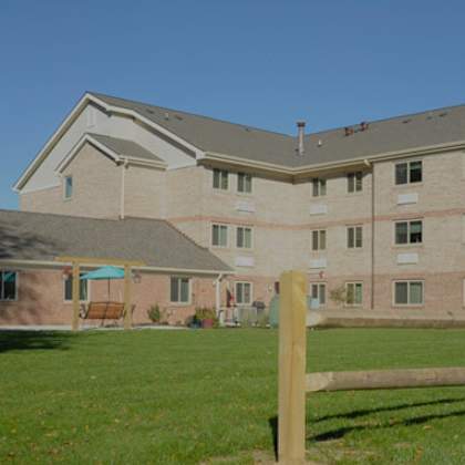 a large building with a brown fence in front.