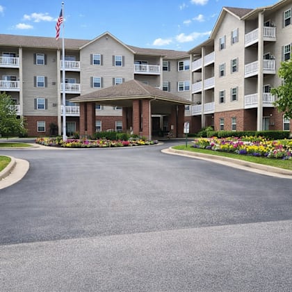 a large apartment complex with a flag flying in front.