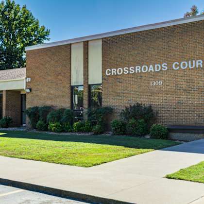 a brick building with the words "crossroads court" on the side.