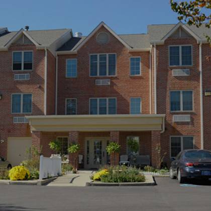 a large brick building with a covered walkway leading to the front door.