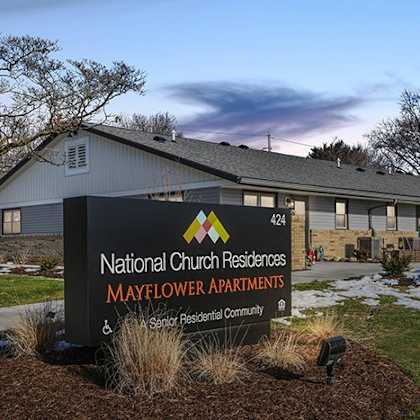 the sign in front of the building says national church residences mayflower and senior residential community.