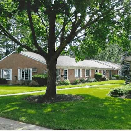 a tree in front of a house with the number 803 on it.