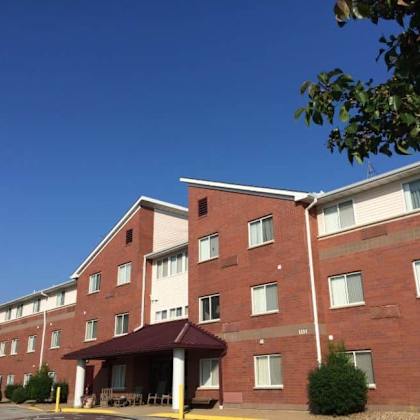a large red brick building with a covered outdoor seating area.