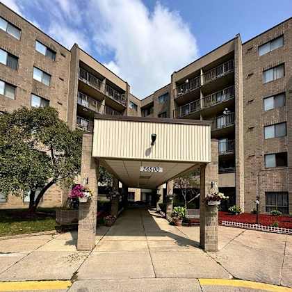 the entrance to apartment building 36500 with a covered walkway.
