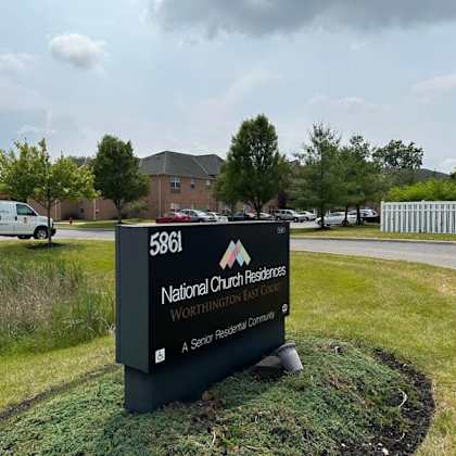 a sign for national church research center sits in front of a grassy area.