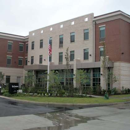 a building with a flag on a pole in front of it.