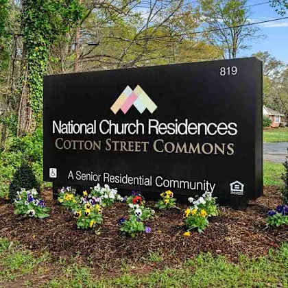 a sign for national church residences cotton street commons, a senior residential community.