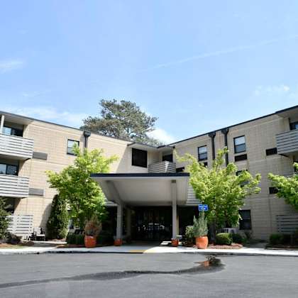 a large building with a parking lot in front of it.