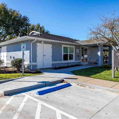a community building office is located in a well-maintained area with a clear sky.