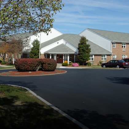 a large building with a parking lot in front of it.