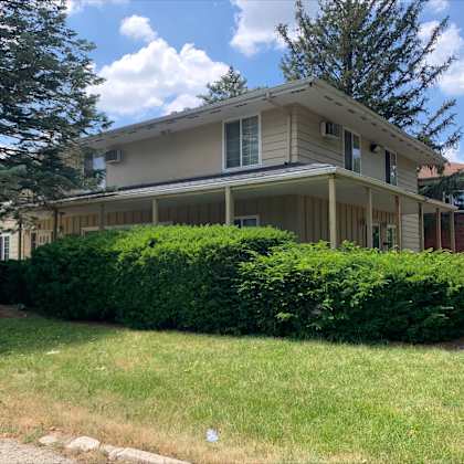 a house with a well-maintained green lawn in front.