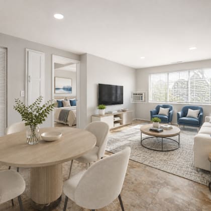 a modern living room with a round table and chairs.