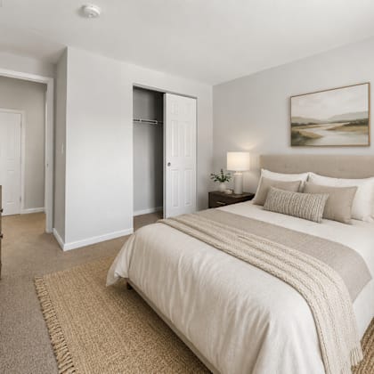 a bedroom with a large bed and a painting on the wall.