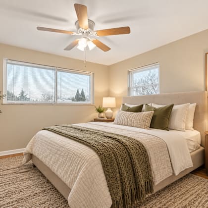 a bedroom with a large bed and a ceiling fan.