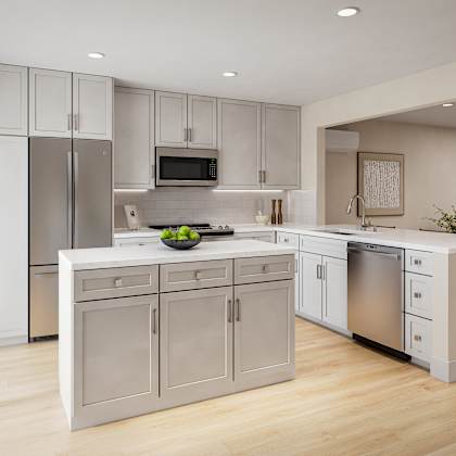 a modern kitchen with a refrigerator, microwave, oven, and sink.