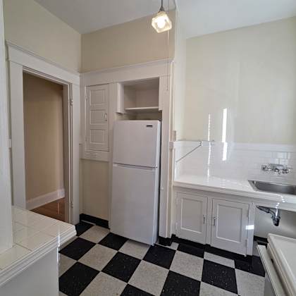a black and white checkered floor in a kitchen. at casa del rey apartments, portland