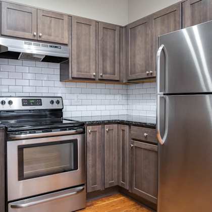 a modern kitchen with a stainless steel refrigerator, oven, and microwave.
