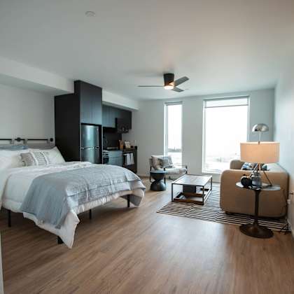 a bedroom with a bed and a living room with a window at analog tacoma, washington 98402