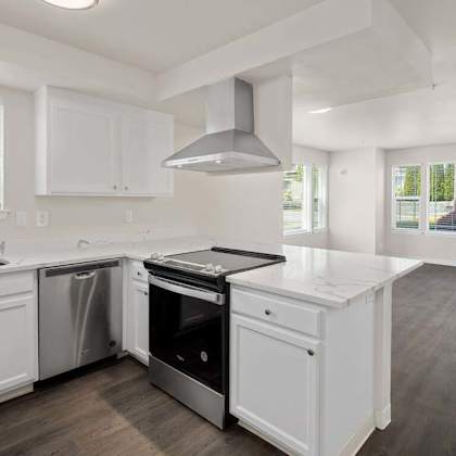 a kitchen with a stove top oven next to a sink