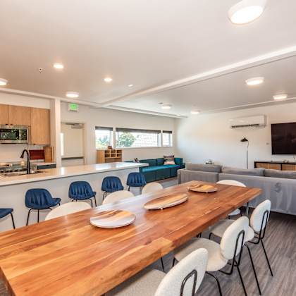 a modern kitchen with a dining table and chairs at society 62 apartments, oregon