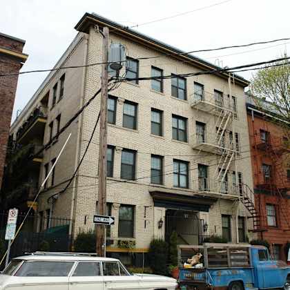 an apartment building on the corner of a city street